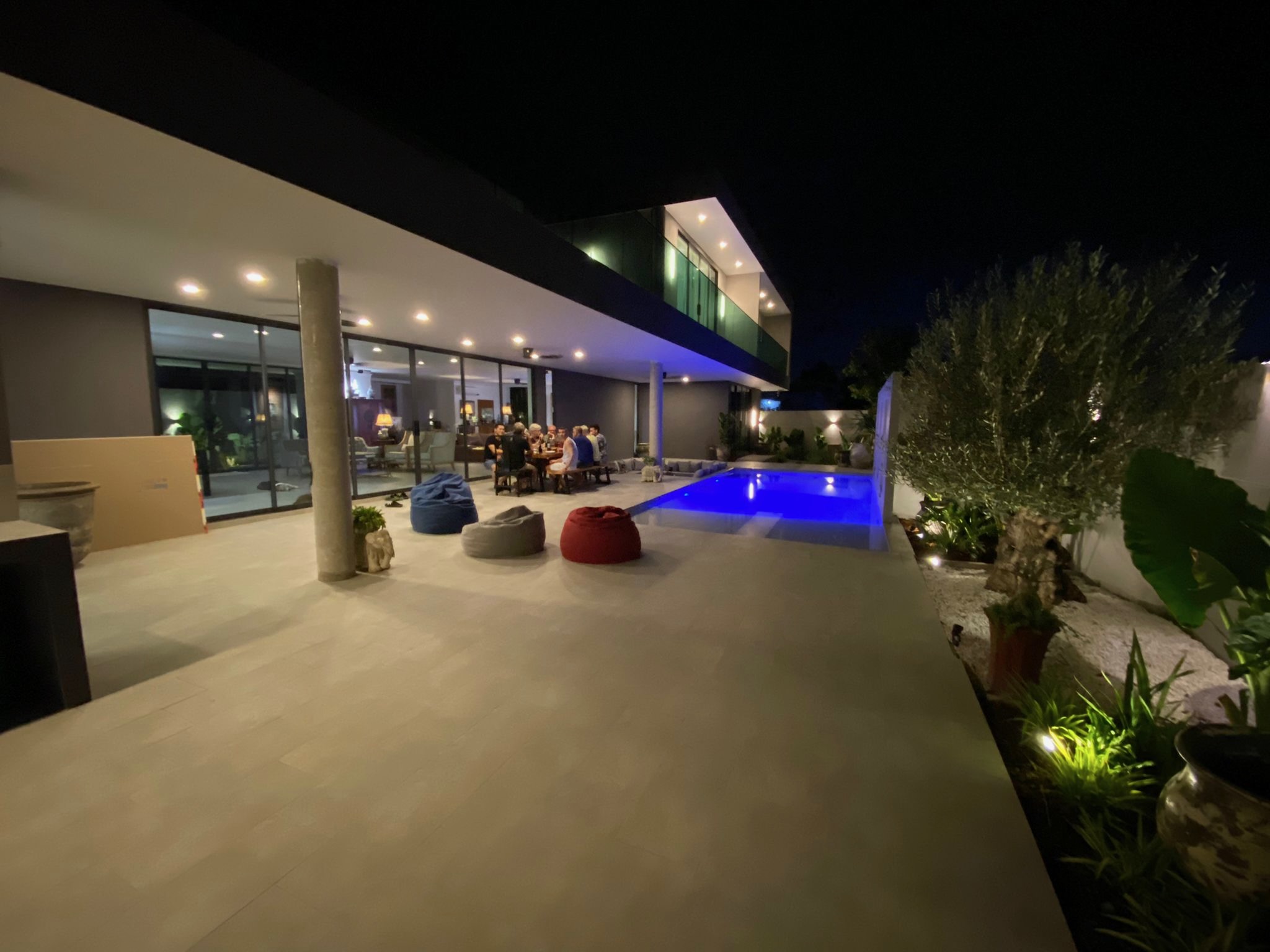 Villa Koh outdoor entertaining area at night with glowing pool